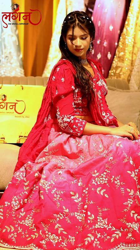 A pink lehenga, seated on the showroom sofa