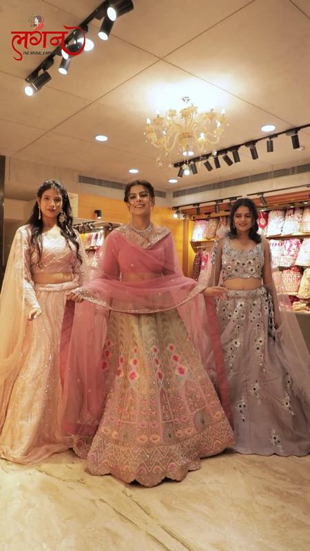 3 friends in pastel lehengas in the showroom